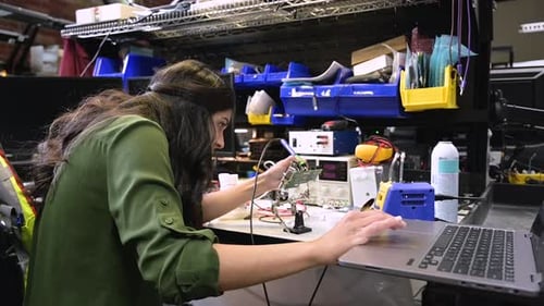 Focused Female Engineer Assembling Semiconductor in Office 2529 Years