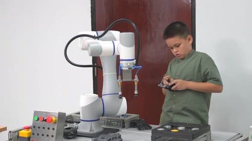 schoolkids learning using gadgets and building robots on software robotics engineering class.