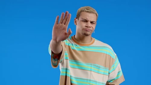 Serious Man Showing Rejecting Gesture By Stop Finger Sign