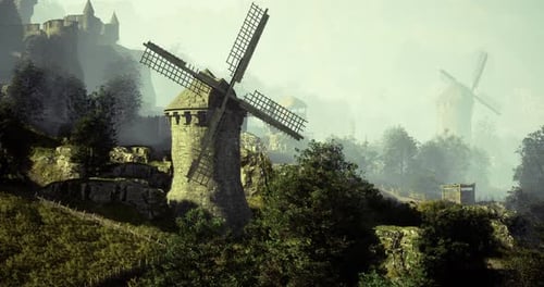 Historic Windmills Stand Majestically in a Misty Landscape at Dawn