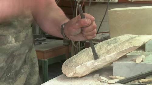 The sculptor shapes the stone