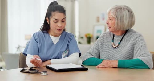 Doctor Consults with Senior Patient at Home
