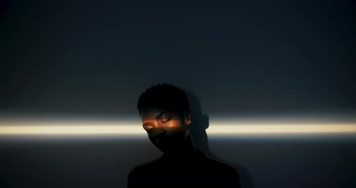 Contemplative Young Adult with Moody Lighting