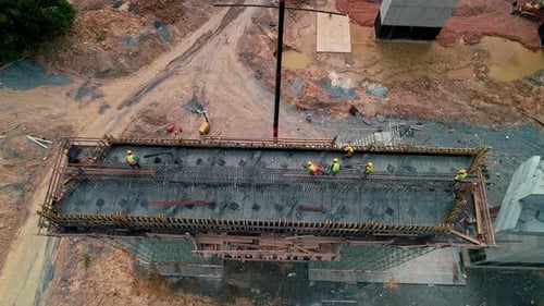 Workers Installing Rebar on Bridge Deck at Highway Construction Site