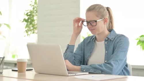 Woman Working at her Computer Gets a Headache