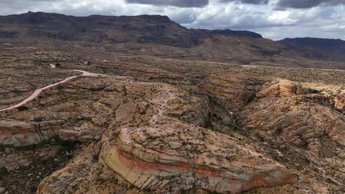 Aerial view of desert landscape with winding road, United States.