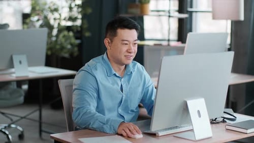 Young Professional Working at a Computer in a Modern Office During Daytime