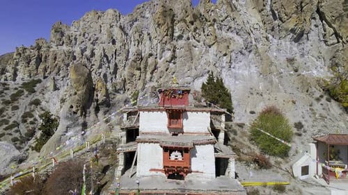 Flying backwards over Bhraka Gomba in Nepal viewing the area