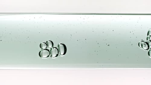 Translucent Bubbles Rising Slowly Through Clear Liquid