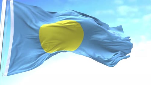 Palau National Flag Waving Against a Clear Blue Sky