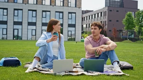 Couple Freelancers Sitting Grass Urban Park Enjoying Coffee Smiling Man Woman