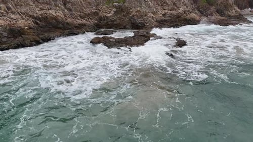 Dynamic Ocean Waves Crashing on Black Stones with Strong Motion