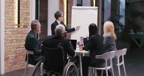 Diverse Team Attends Corporate Presentation in Office