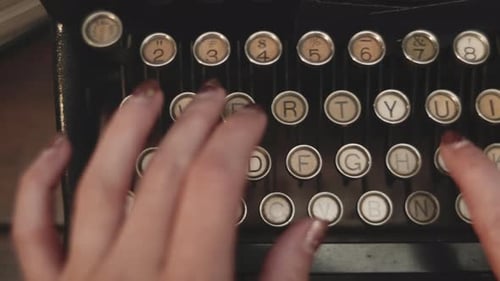 Female hand is typing text on old historic typewriter,close up dolly shot