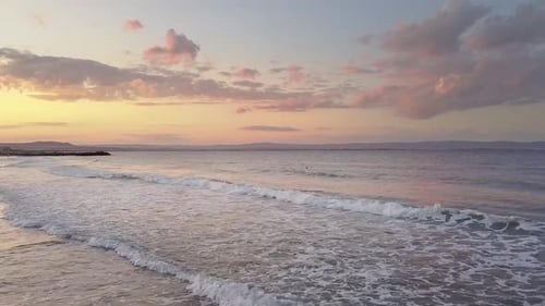 Aerial View of a Sea Surface with Blue Water Waves Under Sunset Sky