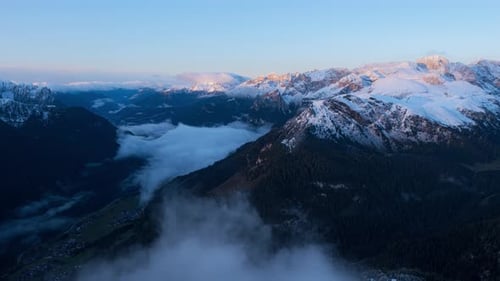 Timelapse of clouds formation in front of camera and beautiful snowy mountain landscape in backgroun