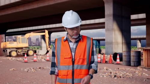 Asian Male Engineer Having A Headache While Working At Building Site