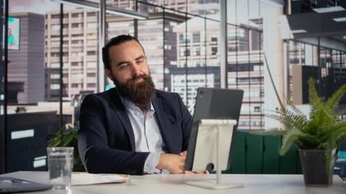 Bearded Man Having Video Call in Office Building
