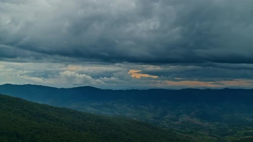 Timelapse of Clouds Moving in the Blue Sky Above the Mountains and Green Hills