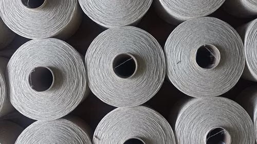 Spools of Undyed Thread in Textile Factory