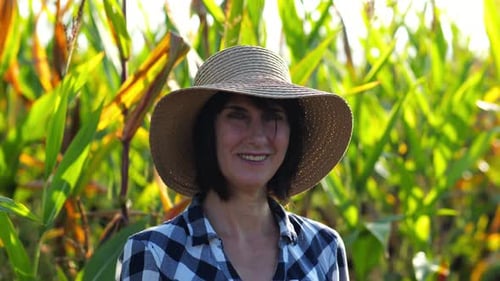 Happy Smiling Female Farmer Looks Into Camera Standing Near Corn Field Portrait of Adult Beautiful