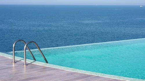 Pool with Stairs with Sea and Horizon at Background