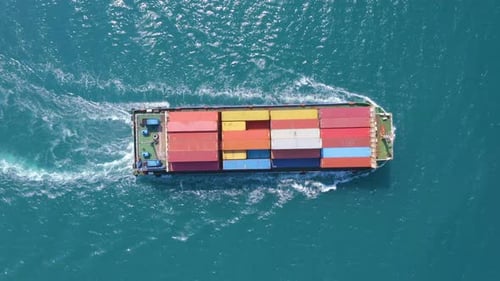 Top Down Aerial View Of A Large Container Ship Sailing At The Sea For Transporting.