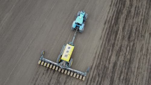 Blue tractor OA working on the field in Ukraine