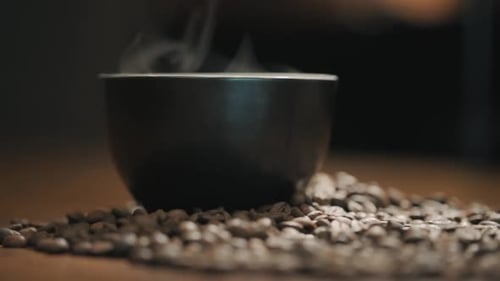 A cup of coffee with fragrant steam, natural coffee on a wooden table 120F