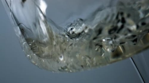 Effervescent liquid being poured into clear glass