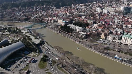Aerial view of Tbilisi city central park and Bridge of Peace. Beautiful cityscape of Tbilisi