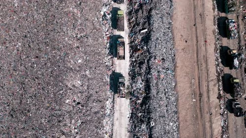 Large Waste Dump and Trash Truck with Garbage in Aerial Top View