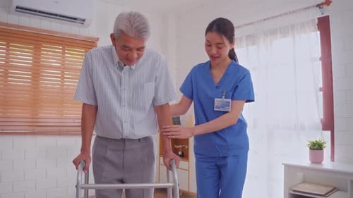 Senior Man Using Walker with Nurse Assisting