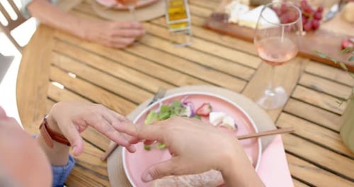 Senior people dine at an outdoor table
