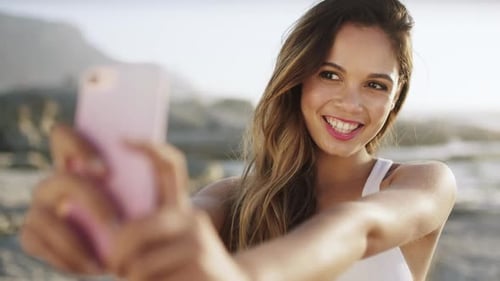 Phone, travel or woman taking selfie at a beach for social media content creation with freedom