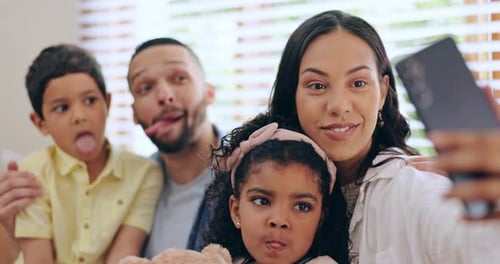 Happy Family Posing for Silly Selfie at Home