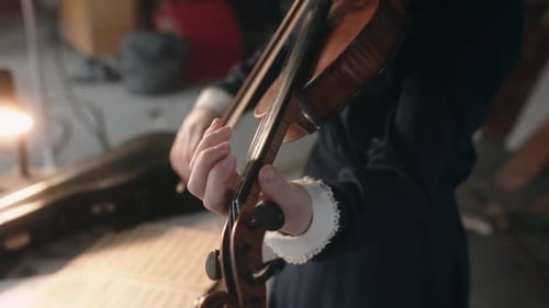 Crop Woman Playing Violin in Evening