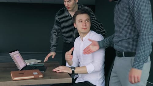 Three Businesspeople Including an Entrepreneur Having a Meeting and Discussing