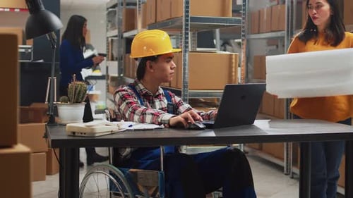 Young Man in Wheelchair Looking at Stock Supplies
