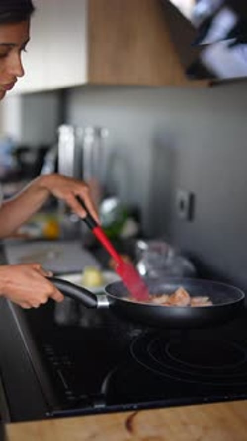 Woman Cooking Food in Modern Kitchen