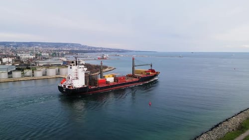 Aerial View of a Cargo Ship Entering the Port of Varna Bulgaria The Ship is Loaded with Colorful