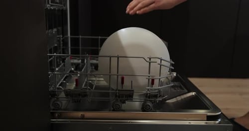 Female Hands Unloading Dishwasher Close Up Modern Technologies for Home