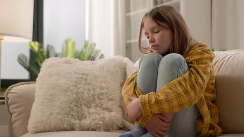 Bored Depressed Caucasian Little Kid Child Offended Schoolgirl Feel Sad Hugging Knees Couch Stressed