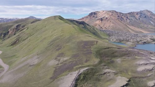 Aerial forward drone view of the hiking path on the left of Frostastaðavatn Lake in Landmannalaugar,