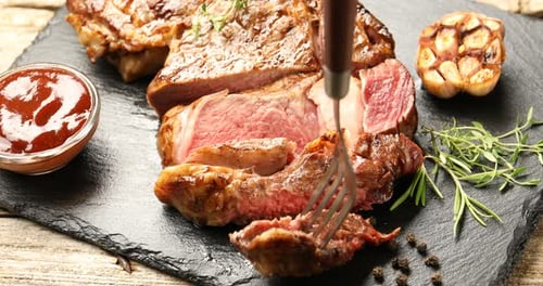 Delicious Steak Being Cut on Serving Board