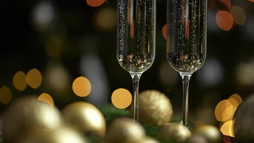 Festive Champagne Celebration with Gold Christmas Ornaments