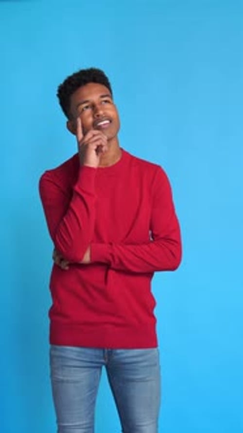 Cheerful Black Man with Pensive Gesture