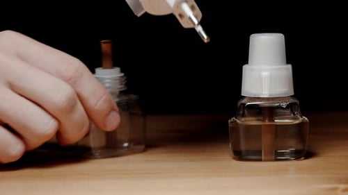 Hands Assembling a Plug-in Air Freshener