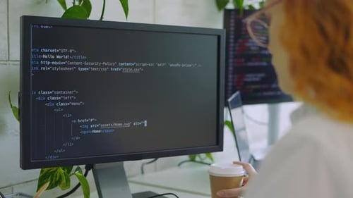 Back View Caucasian IT Programmer Working on Desktop Computer Writing Code in Terminal Freelance