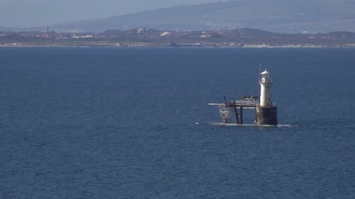 lighthouse in the middle of the bay